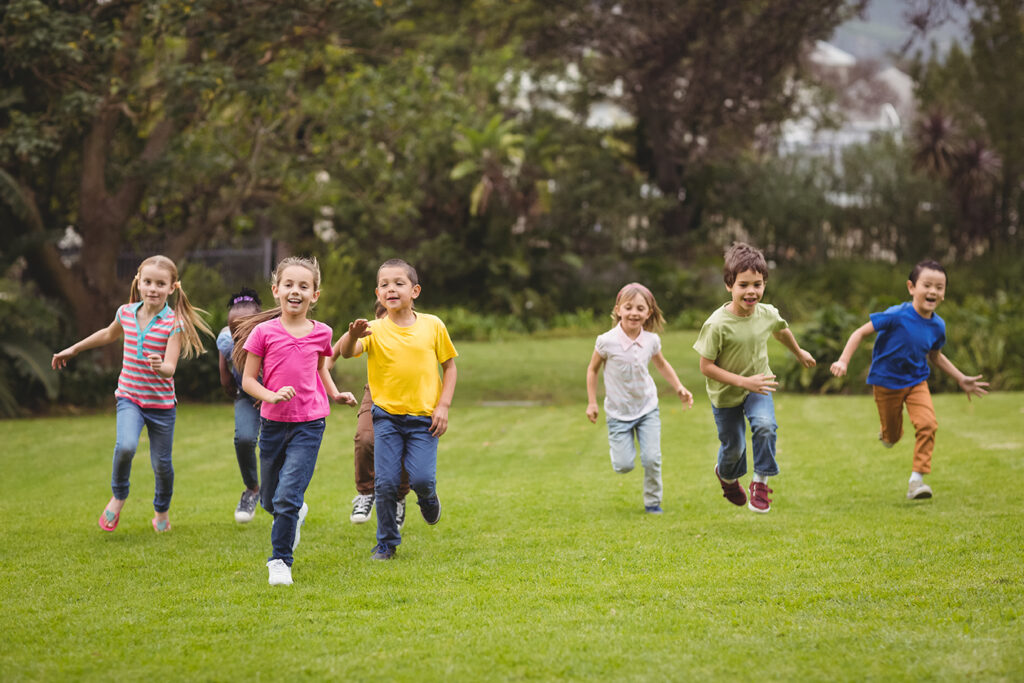 Cute pupils running towards camera on elementary school campus